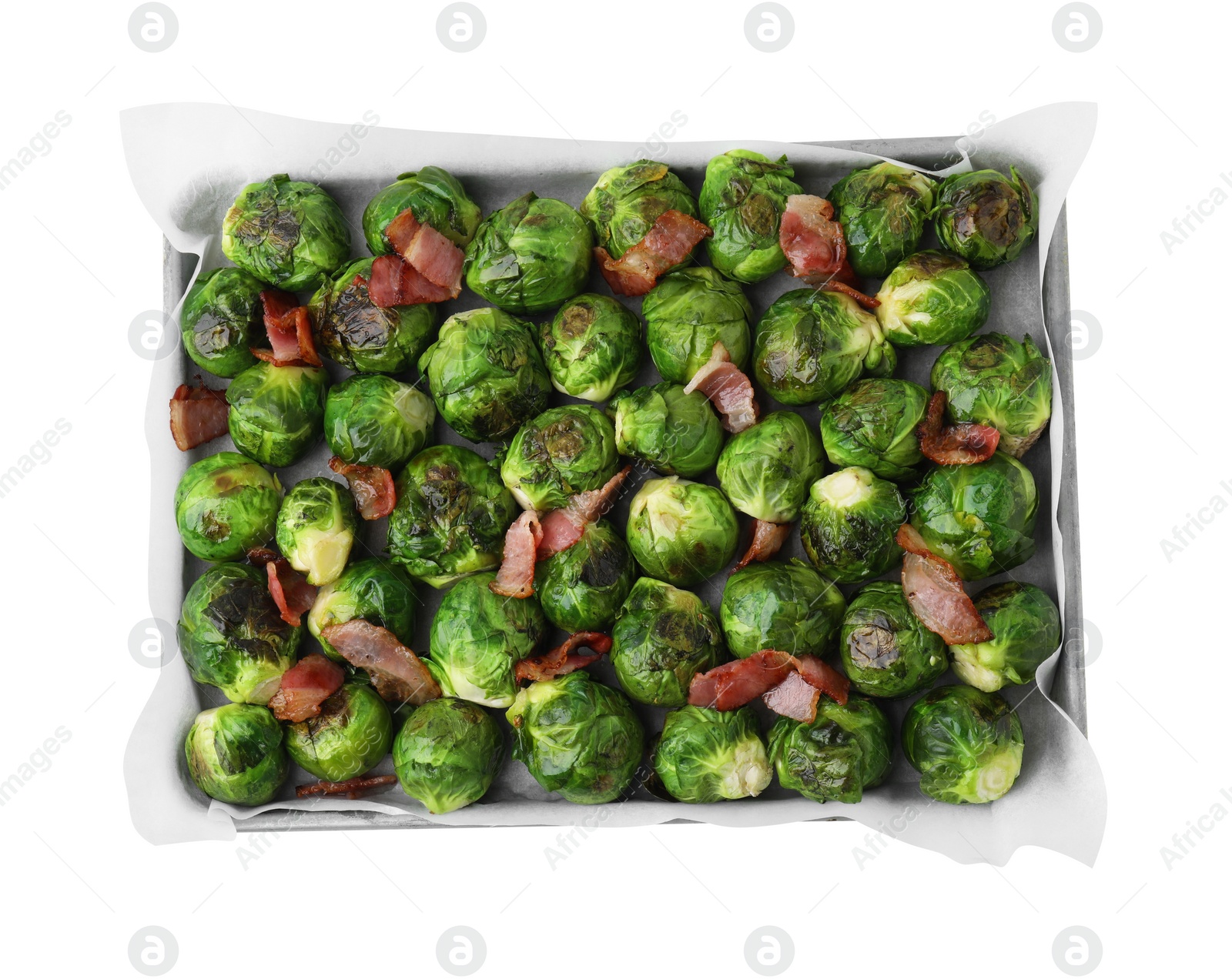 Photo of Delicious roasted Brussels sprouts and bacon in baking dish isolated on white, top view