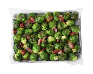 Photo of Delicious roasted Brussels sprouts and bacon in baking dish isolated on white, top view