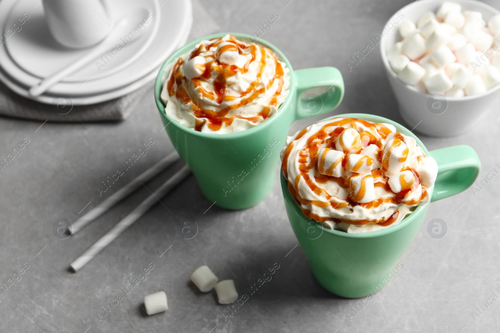 Photo of Cups with delicious caramel frappe on table