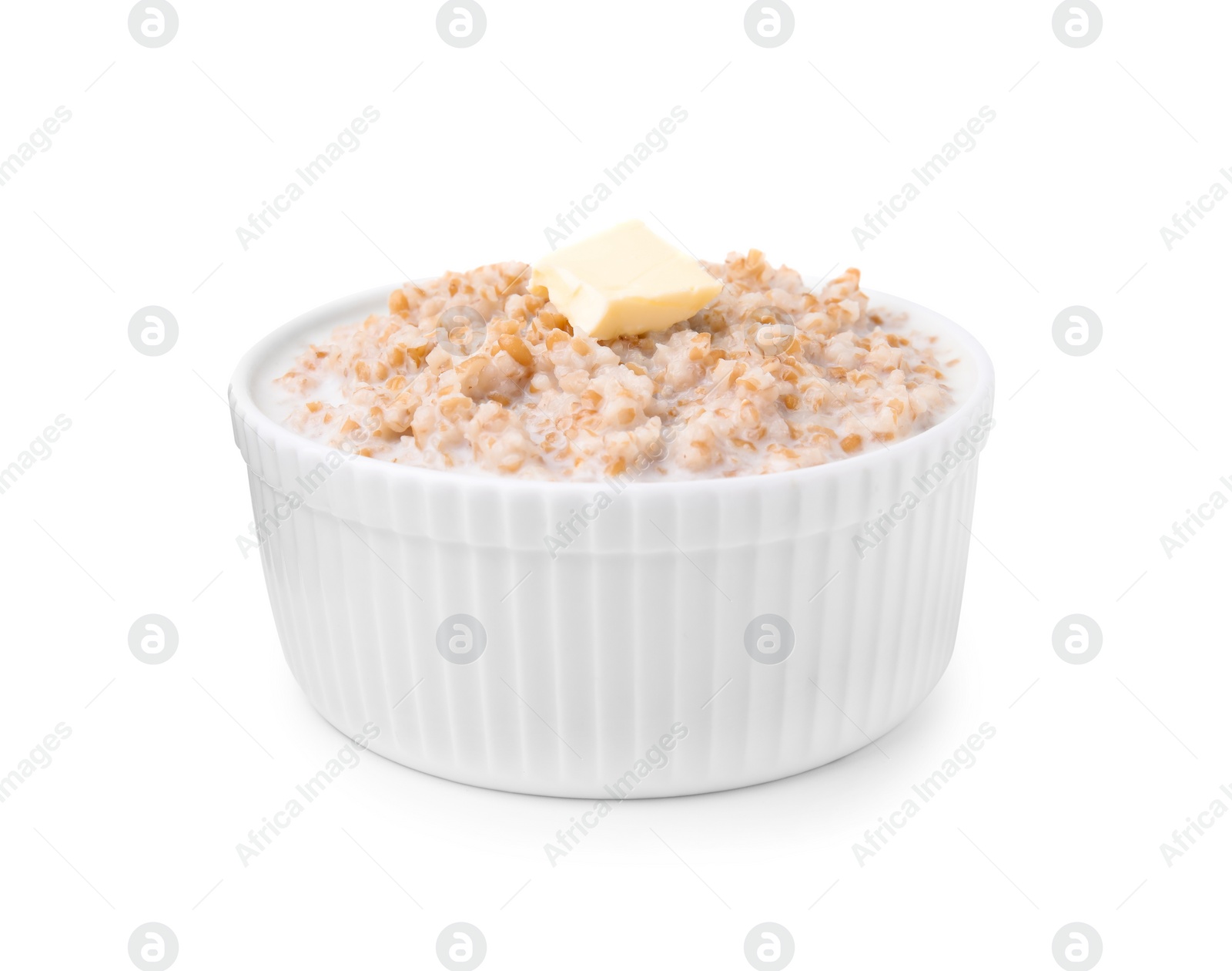 Photo of Tasty wheat porridge with milk and butter in bowl isolated on white