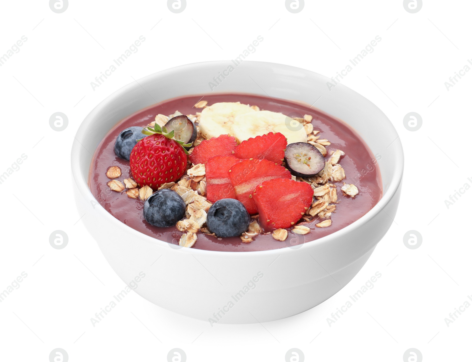 Photo of Delicious smoothie bowl with fresh berries, banana and granola on white background