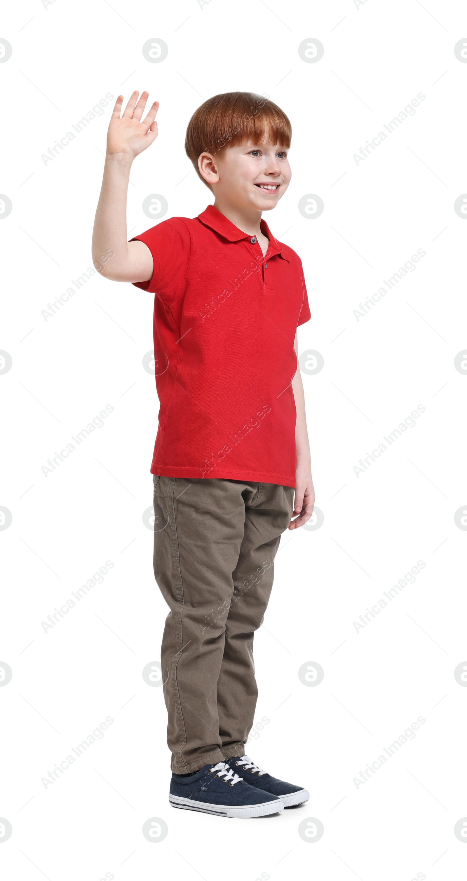 Photo of Smiling little boy waving hand on white background