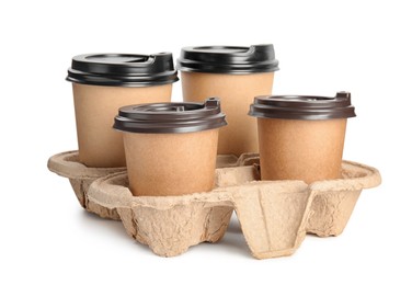 Photo of Takeaway paper coffee cups in cardboard holder on white background