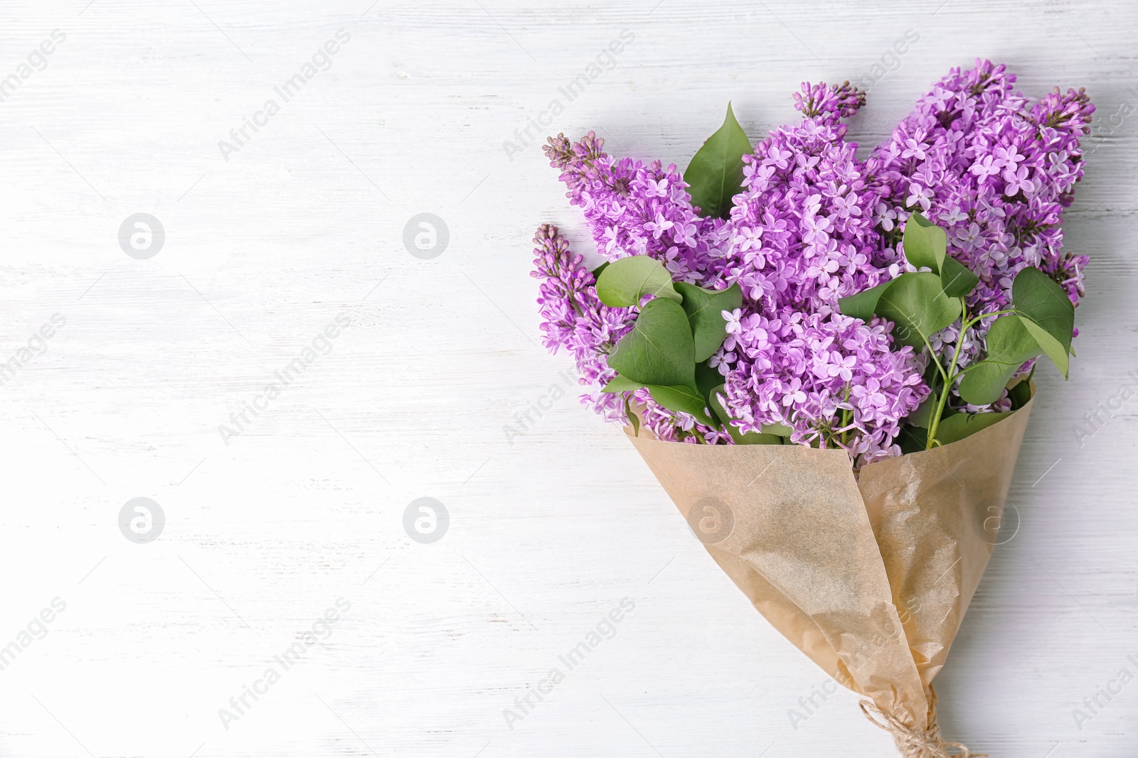 Photo of Blossoming lilac on light background, top view. Spring flowers