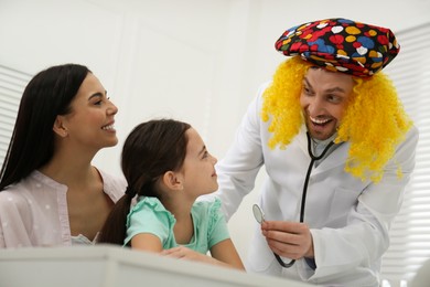 Photo of Mother with daughter visiting funny pediatrician in hospital