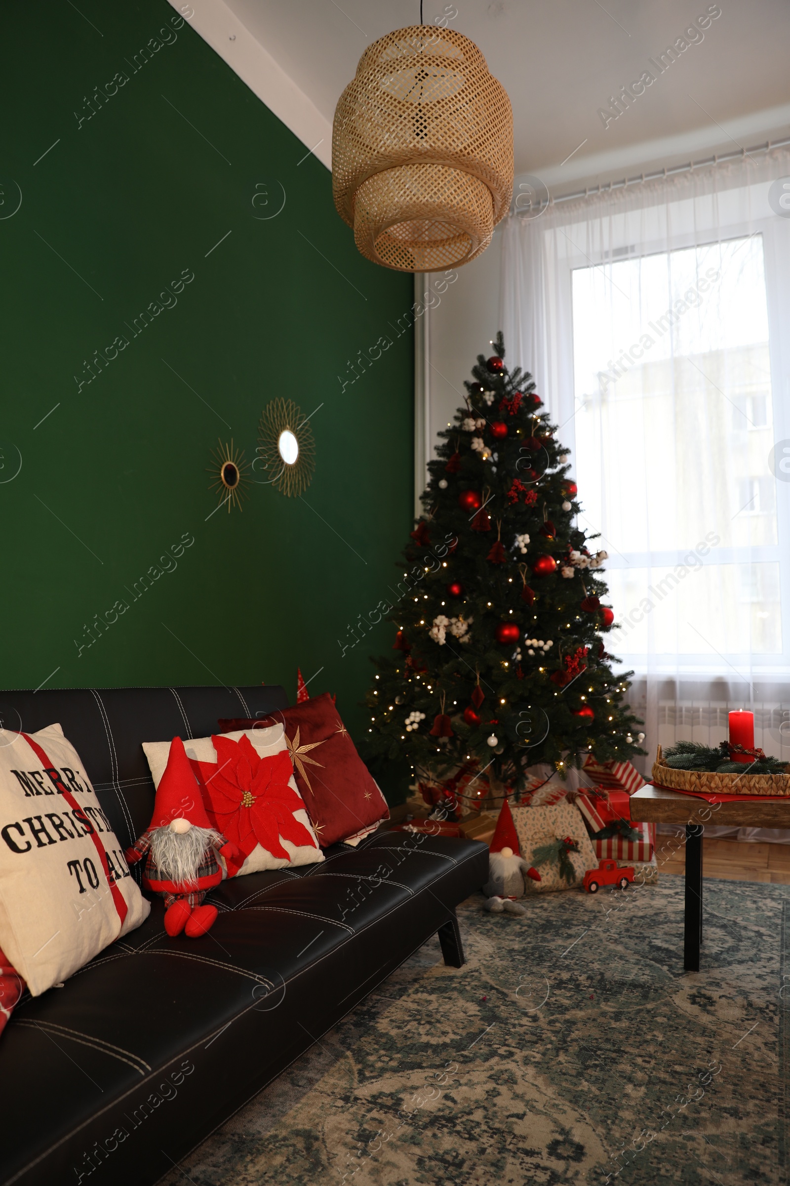 Photo of Cozy room with sofa, Christmas tree and festive decor. Interior design