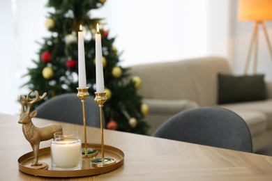 Photo of Beautiful Christmas composition with burning candles on table indoors