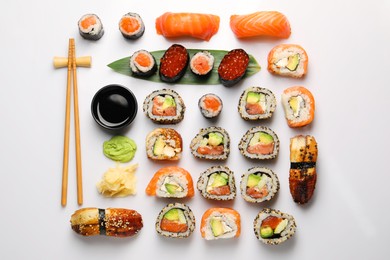 Photo of Set of delicious sushi rolls on white background, flat lay