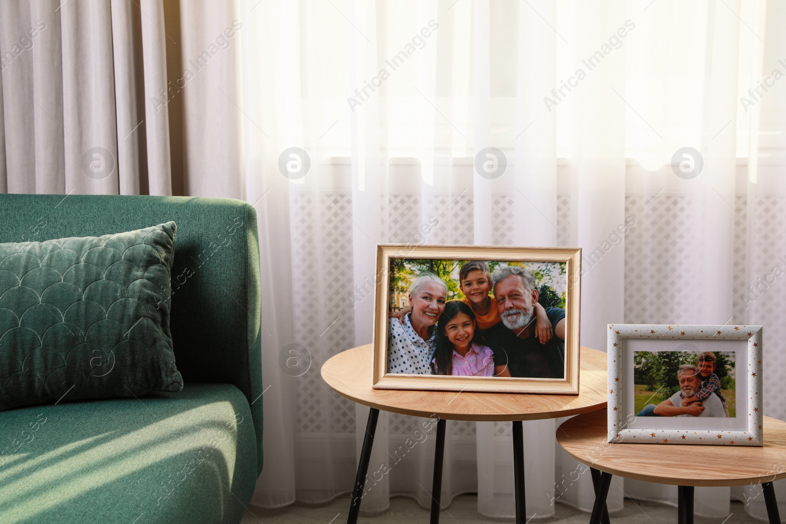 Photo of Framed family portraits in living room at home