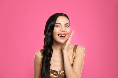 Photo of Portrait of surprised woman on pink background
