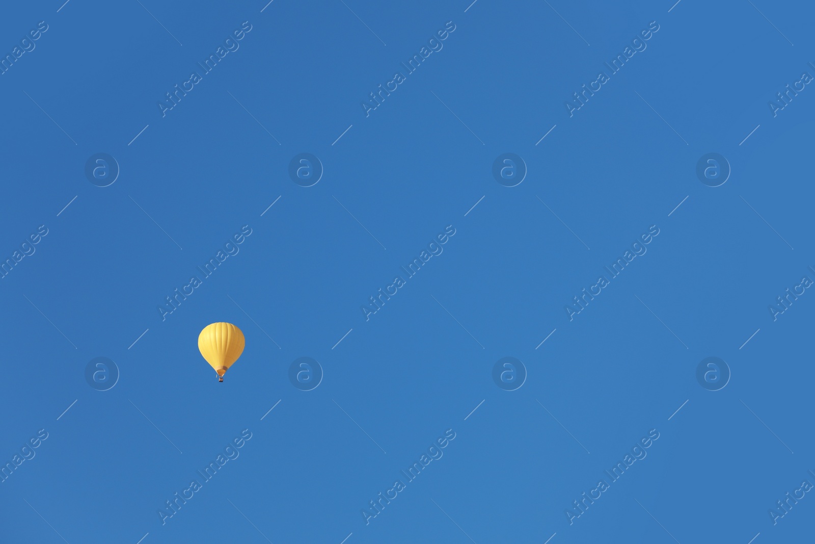 Photo of Colorful hot air balloon flying in blue sky. Space for text