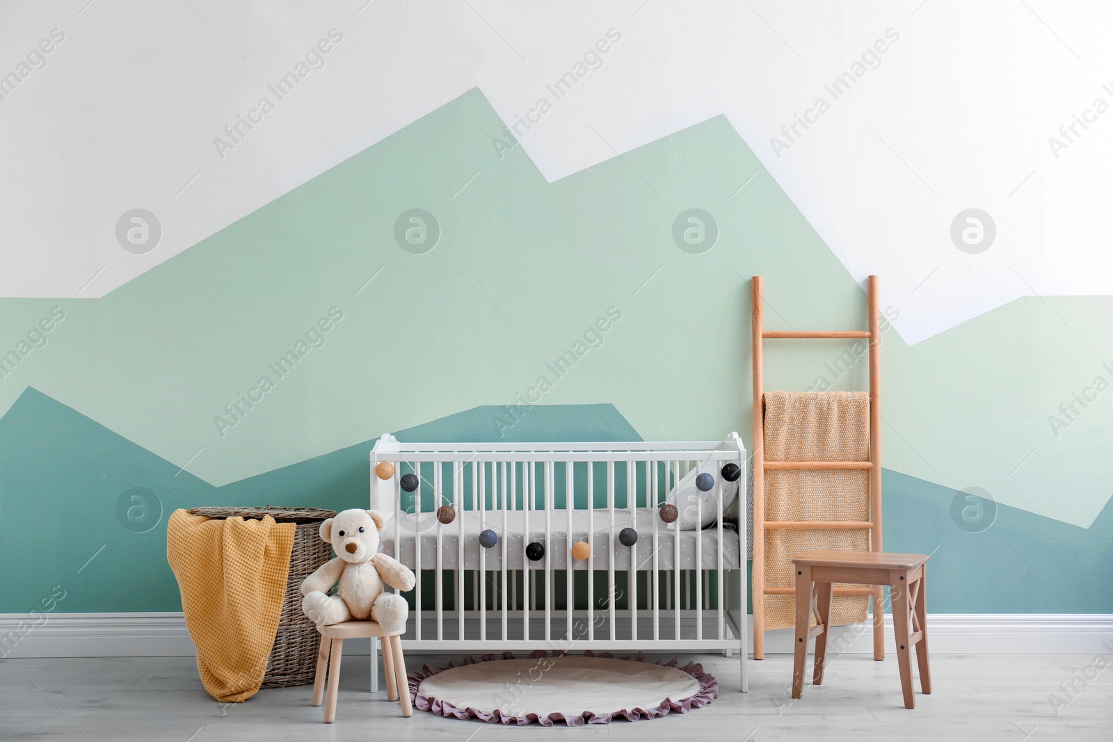 Photo of Baby room interior with crib near wall