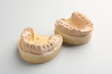 Photo of Dental model with gums on light grey background. Cast of teeth