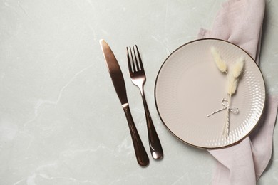 Photo of Stylish setting with elegant cutlery on marble table, top view. Space for text