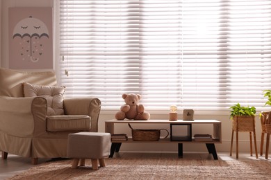 Photo of Beautiful room interior with modern furniture and toy bear