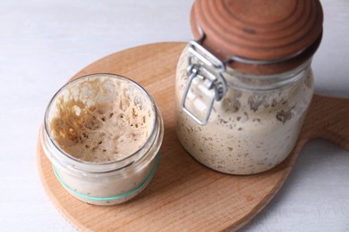 Photo of Sourdough starter in glass jars on light table