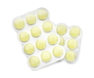 Photo of Blisters with yellow cough drops on white background, top view