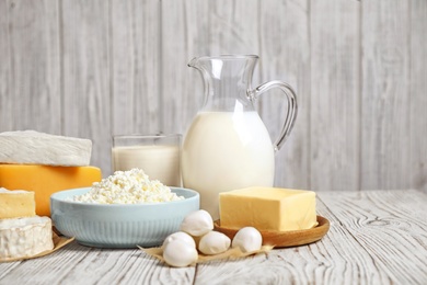 Photo of Different delicious dairy products on white wooden table