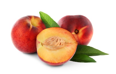 Photo of Sweet juicy peaches with leaves on white background