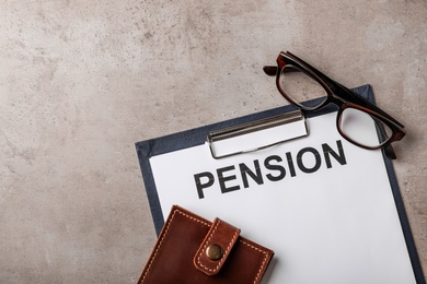 Paper with word PENSION, wallet and glasses on table, top view. Space for text