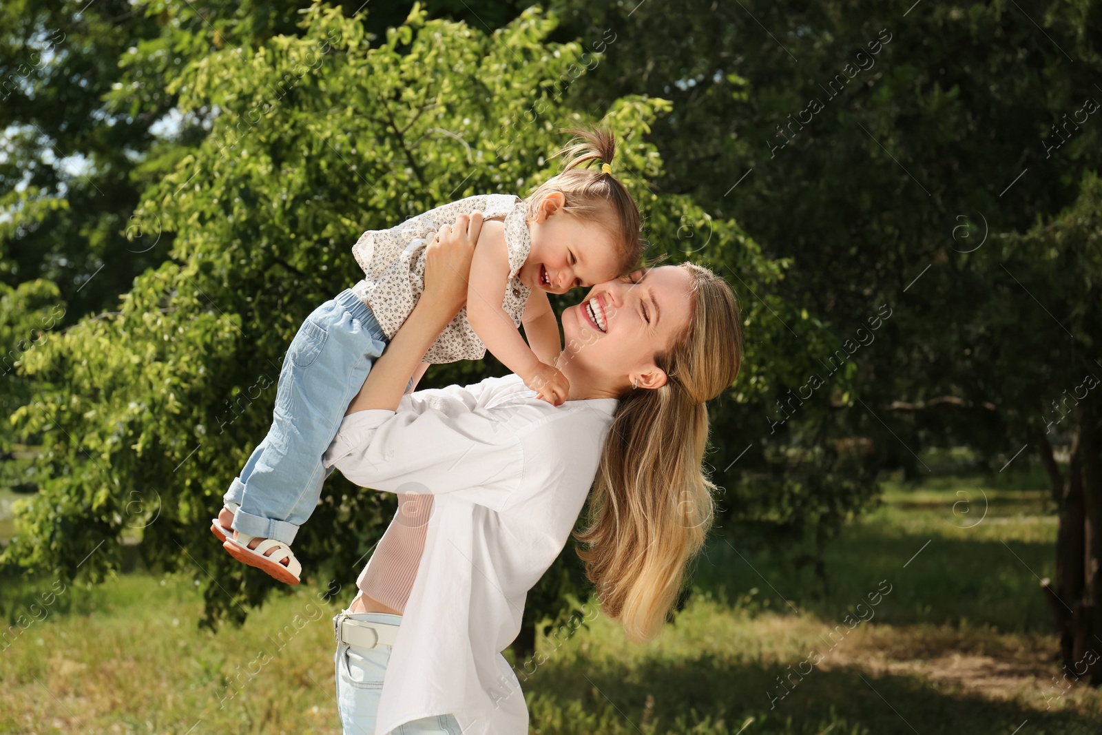 Photo of Happy mother with her daughter having fun in park