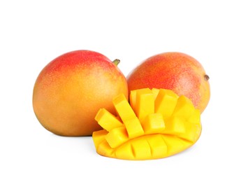 Photo of Delicious whole and cut mangoes on white background