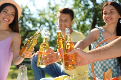 Photo of Young people enjoying picnic in park on summer day
