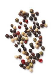Photo of Aromatic spices. Pile of different peppers isolated on white, top view