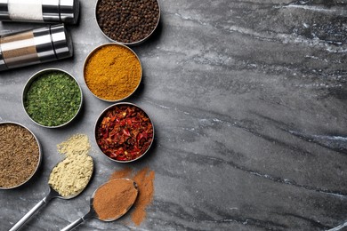 Photo of Flat lay composition with different spices on grey marble table, space for text