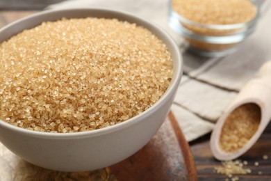 Photo of Brown sugar in bowl on table, closeup