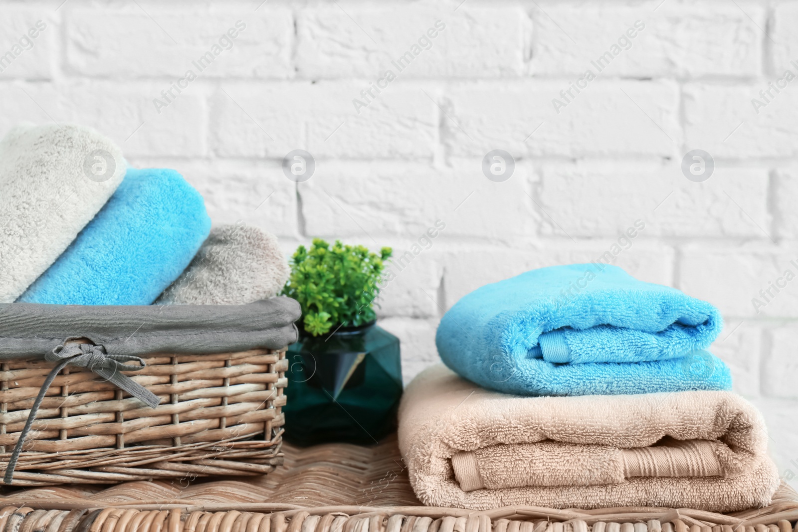 Photo of Clean towels near brick wall in bathroom