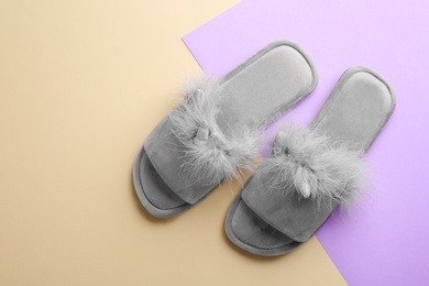 Photo of Pair of stylish soft slippers on color background, flat lay. Space for text