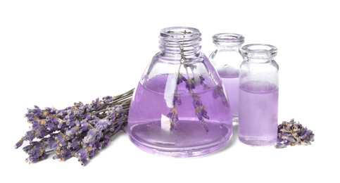 Photo of Bottles with aromatic lavender oil on white background