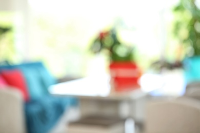 Photo of Blurred view of room decorated with beautiful tropical flowers