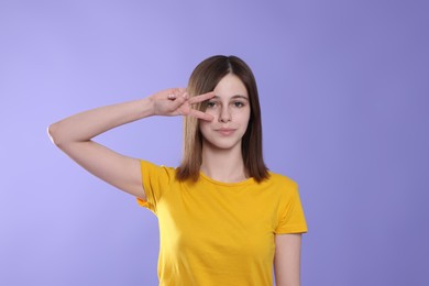 Photo of Portrait of cute teenage girl on violet background
