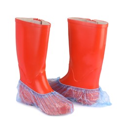 Photo of Rubber boots in blue shoe covers isolated on white