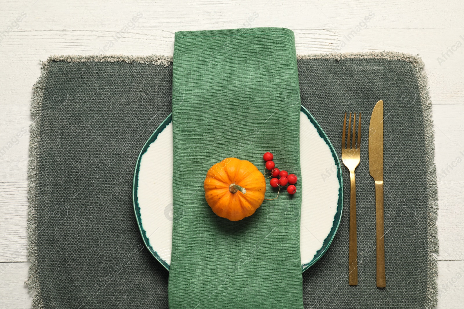 Autumn table setting, pumpkin and red berries, flat lay Photo of Autumn table setting, pumpkin and red berries, flat lay