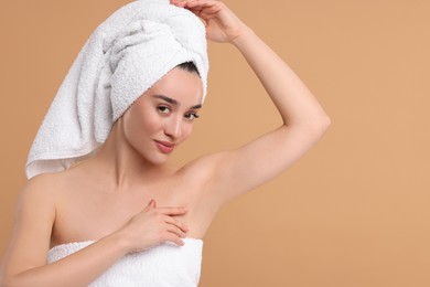 Photo of Beautiful woman showing armpit with smooth clean skin on beige background