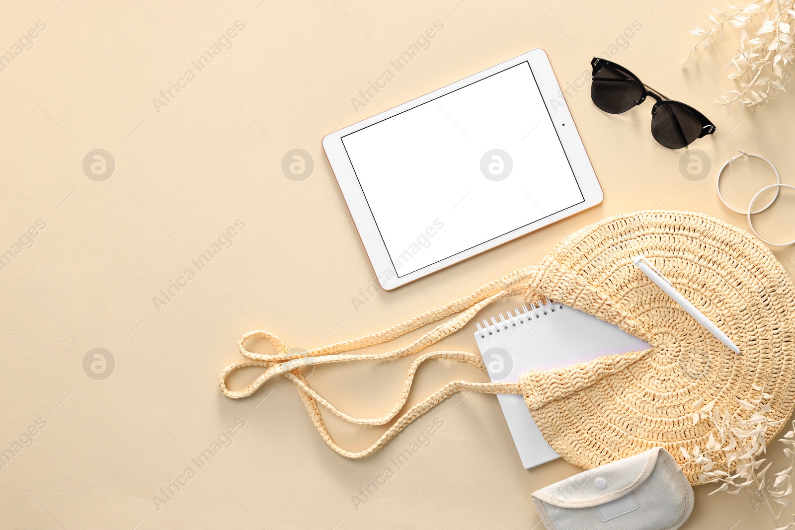 Photo of Flat lay composition with modern tablet on beige background. Space for text