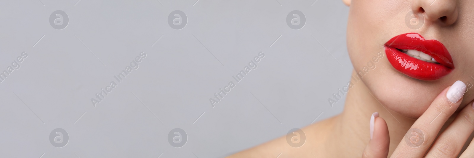 Image of Woman with beautiful red lips on light grey background, closeup view with space for text. Banner design