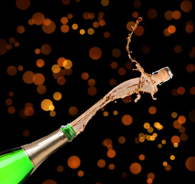 Image of Champagne splashing out of bottle on color background 