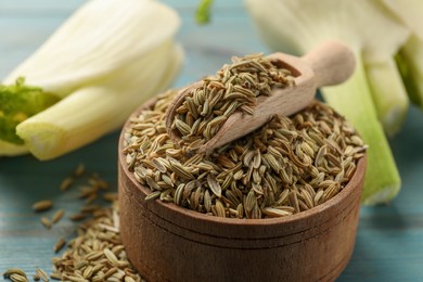 Bowl and scoop with fennel seeds on table, closeup