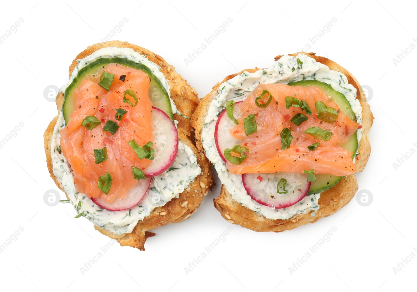 Photo of Tasty canapes with salmon, cucumber, radish and cream cheese isolated on white, top view