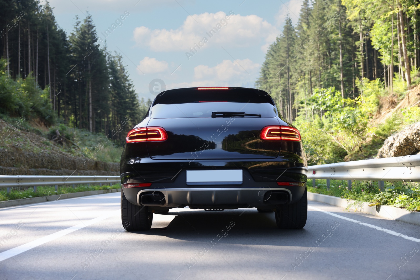 Photo of Picturesque view of asphalt road with modern car