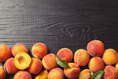 Photo of Flat lay composition with ripe peaches on wooden background