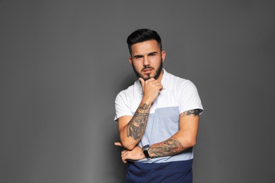 Photo of Portrait of handsome young man on gray background