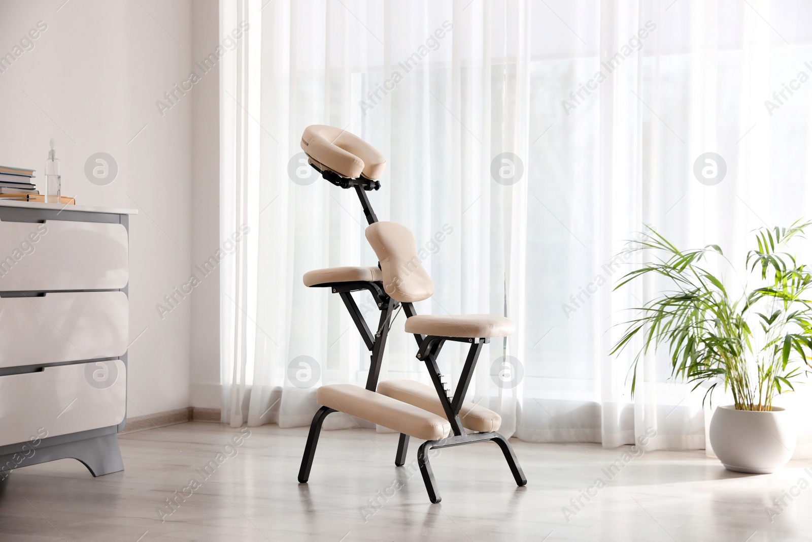 Photo of Modern massage chair in clinic. Medical equipment