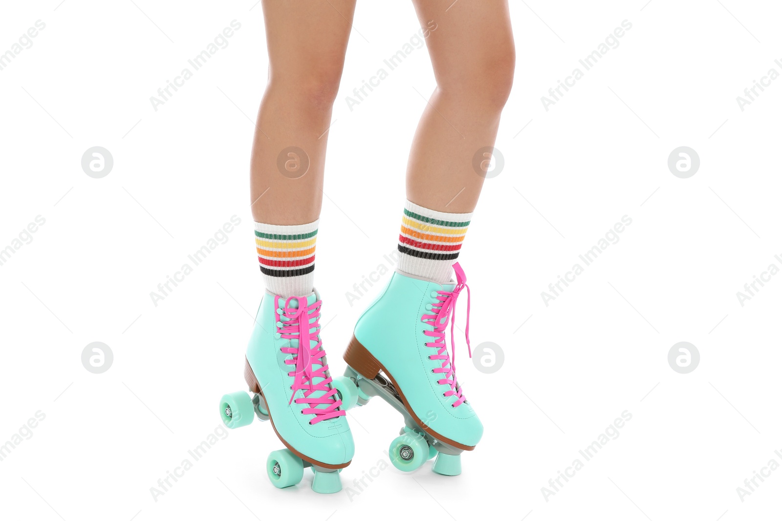 Photo of Young woman with vintage roller skates on white background, closeup view