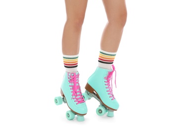 Photo of Young woman with vintage roller skates on white background, closeup view