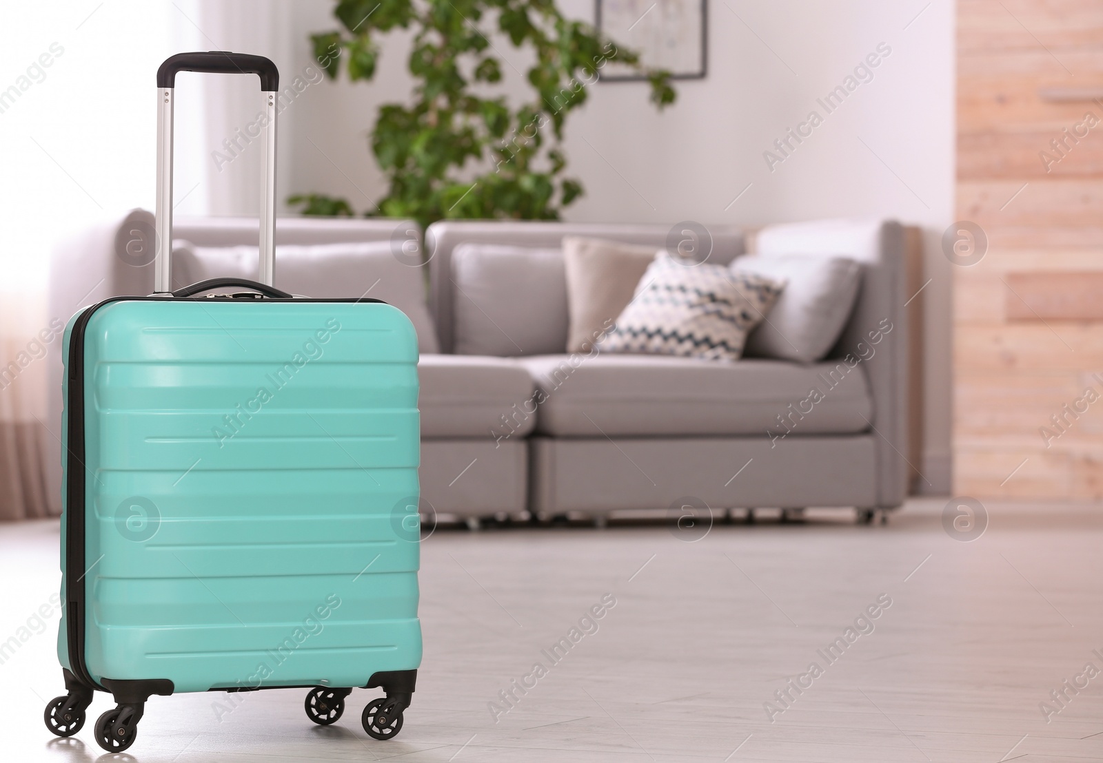 Photo of Colorful suitcase packed for journey in living room. Space for text